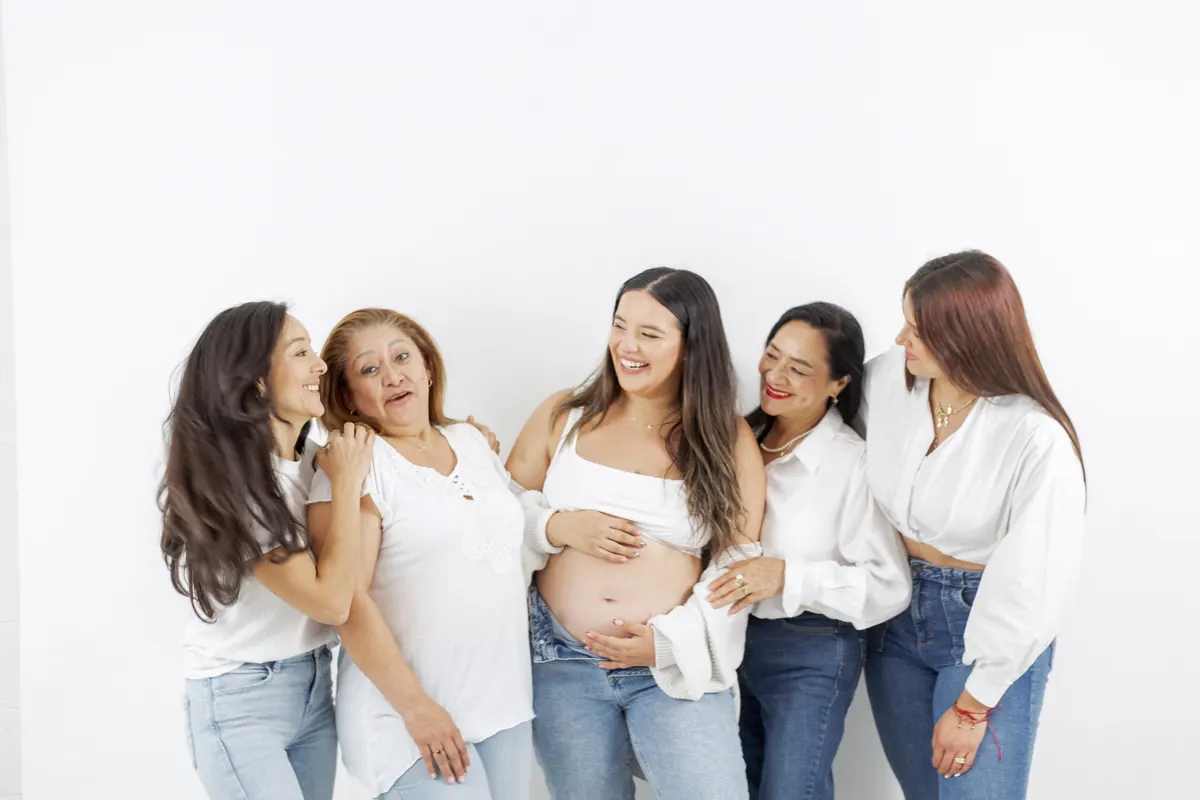 A group of women in white laughing together